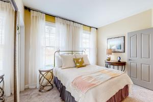 a bedroom with a bed with white walls and windows at Millville by the Sea --- 39008 Seascape Ct in Millville +51 photos