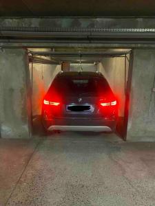 a car in a garage with its lights on at Loft66 avec parking privé in Clermont-Ferrand