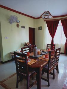 a dining room with a wooden table and chairs at tulia liqizo homestay in Mombasa