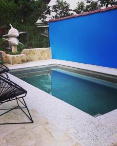 a swimming pool with a blue screen in a backyard at Venus in Montezuma