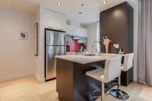 a kitchen with a counter and a refrigerator at Les Immeubles Charlevoix - Le 760206 in Quebec City