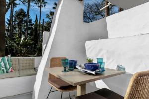 a table with blue glasses on it on a patio at Super Stylish apartment in La Alcazaba - RDR172 in Marbella