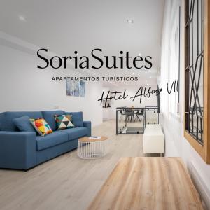 a living room with a blue couch and a table at Apartamentos Soria Suites in Soria