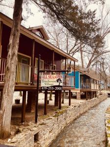 a row of houses with a sign in front of it at All Seasons Inn in Eureka Springs