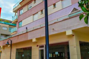 a building with two blue poles in front of it at Isabel - modern apartment in the center of Moraira in Moraira +11 photos