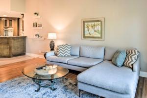a living room with a couch and a table at St Pete Condo with Private Lanai and Community Pool! in St Petersburg