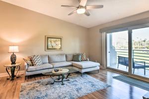 a living room with a couch and a table at St Pete Condo with Private Lanai and Community Pool! in St Petersburg