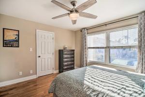 a bedroom with a ceiling fan and a window at St Pete Condo with Private Lanai and Community Pool! in St Petersburg