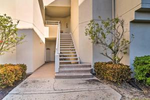 a building with stairs in front of a building at St Pete Condo with Private Lanai and Community Pool! in St Petersburg