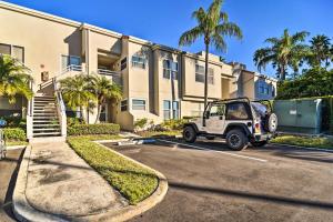 a jeep parked in a parking lot in front of a building at St Pete Condo with Private Lanai and Community Pool! in St Petersburg