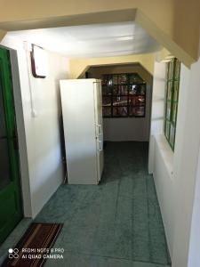 an empty hallway with a refrigerator in a room at Cabana in poiana padurii in Recaş