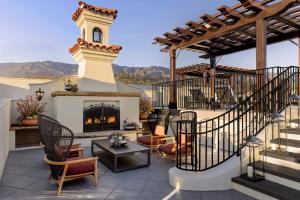 a patio with a fireplace and a clock tower at Kimpton Canary Hotel by IHG in Santa Barbara