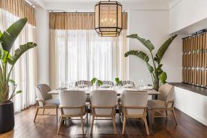 a dining room with a table and chairs and a chandelier at Kimpton Canary Hotel by IHG in Santa Barbara