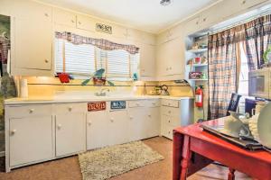 a kitchen with white cabinets and a sink at Artsy Getaway about 8 Miles to Downtown Kansas City! in Independence