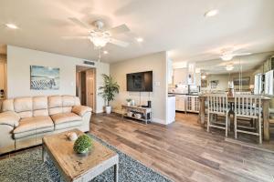 a living room with a couch and a table at Bright and Breezy Condo, 2 Mi to Whitecap Beach! in Corpus Christi