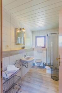 a bathroom with a sink and a toilet at Gästehaus Chalet-Perle in Bad Füssing