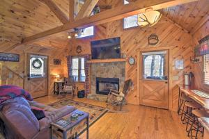 a living room with a couch and a fireplace at Helen Cabin with Deck and Hot Tub Less Than half Mi to Main St in Helen