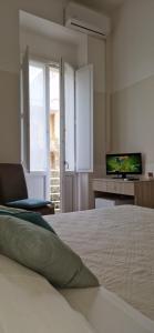 Postel nebo postele na pokoji v ubytování DIAZ Rooms