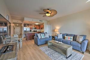 a living room with a couch and a table at Comfy PCB Condo with View and Private Beach Access! in Panama City Beach