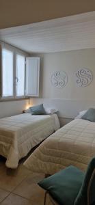 Postel nebo postele na pokoji v ubytování DIAZ Rooms