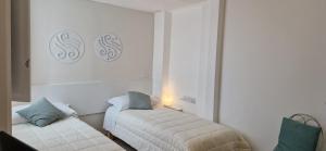 Postel nebo postele na pokoji v ubytování DIAZ Rooms