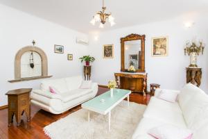 a living room with white furniture and a mirror at Villa Marini Dvori - with free parking in Dubrovnik