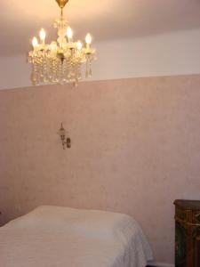 a bedroom with a chandelier hanging from the ceiling at ACCI Cannes Old City in Cannes