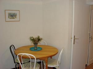 a dining room table with chairs and a vase with flowers at ACCI Cannes Old City in Cannes