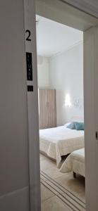 Postel nebo postele na pokoji v ubytování DIAZ Rooms