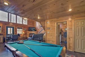 a pool table in a room with wooden walls at Gatlinburg Cabin with Pool Table and Hot Tub! in Gatlinburg