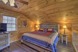a bedroom with a bed and a television in a cabin at Gatlinburg Cabin with Pool Table and Hot Tub! in Gatlinburg