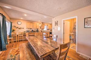 a dining room and kitchen with a wooden table at Cozy Colorado Springs Home Near Garden of the Gods in Colorado Springs