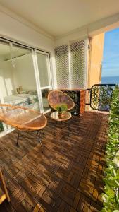 a room with two chairs and a bed on a balcony at Skyblue in Aguadulce