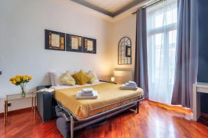a bedroom with a bed and a large window at Milano City Apartments-Porta Venezia-Luxury Apartment in Milan
