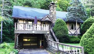 a house with a staircase leading up to a house at Slide Mountain Forest House in Oliverea