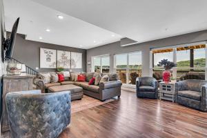 a living room with a couch and two chairs at Give Us This Day Chalet in Hollister