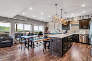a large kitchen with a table and chairs in it at Give Us This Day Chalet in Hollister