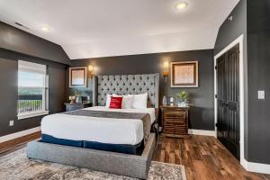 a bedroom with a large bed and a window at Give Us This Day Chalet in Hollister +110 photos