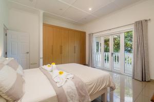 a bedroom with a bed with towels on it at Luxurious 2-Bed Villa in Bel Ombre Mahe Seychelles in Beau Vallon +16 photos