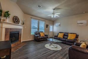 a living room with leather furniture and a fireplace at New Beautiful 4/BR Vacation Home in Katy