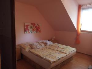 a bedroom with a bed in a attic at Penzion Rose in Štúrovo +5 photos