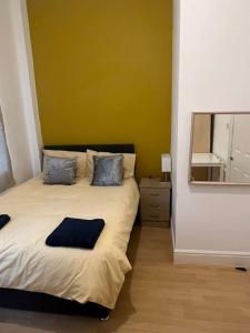 a bedroom with a large bed with a mirror at 001- Lovely 3-bedroom very close to Oxford Street in London