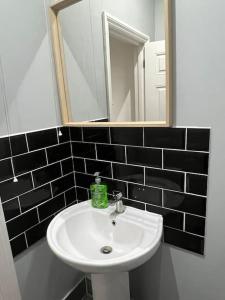 a bathroom with a white sink and a mirror at 001- Lovely 3-bedroom very close to Oxford Street in London
