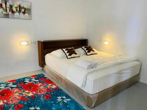 a bed with two pillows on it in a bedroom at Komodo Indah Hotel in Labuan Bajo