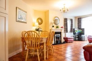 a dining room with a table and chairs at Kerry Holiday Homes at the Killarney Holiday Village in Killarney