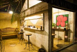 a room with a counter and a table and a window at Pousada Montemar in Ilhabela