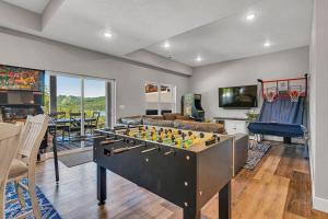 a living room with a large pool table at Absolutely Shore in Hollister