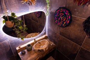a bathroom with a sink and a mirror at Avataar - L'arbre de Pandoraa in Belfort