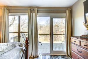 a bedroom with a bed and a sliding glass door at Waterfront Florence Home with Private Dock! in Florence