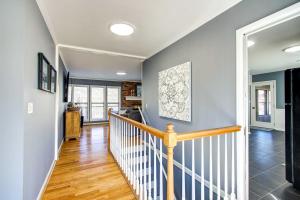 a staircase in a home with blue walls and wood floors at Waterfront Florence Home with Private Dock! in Florence